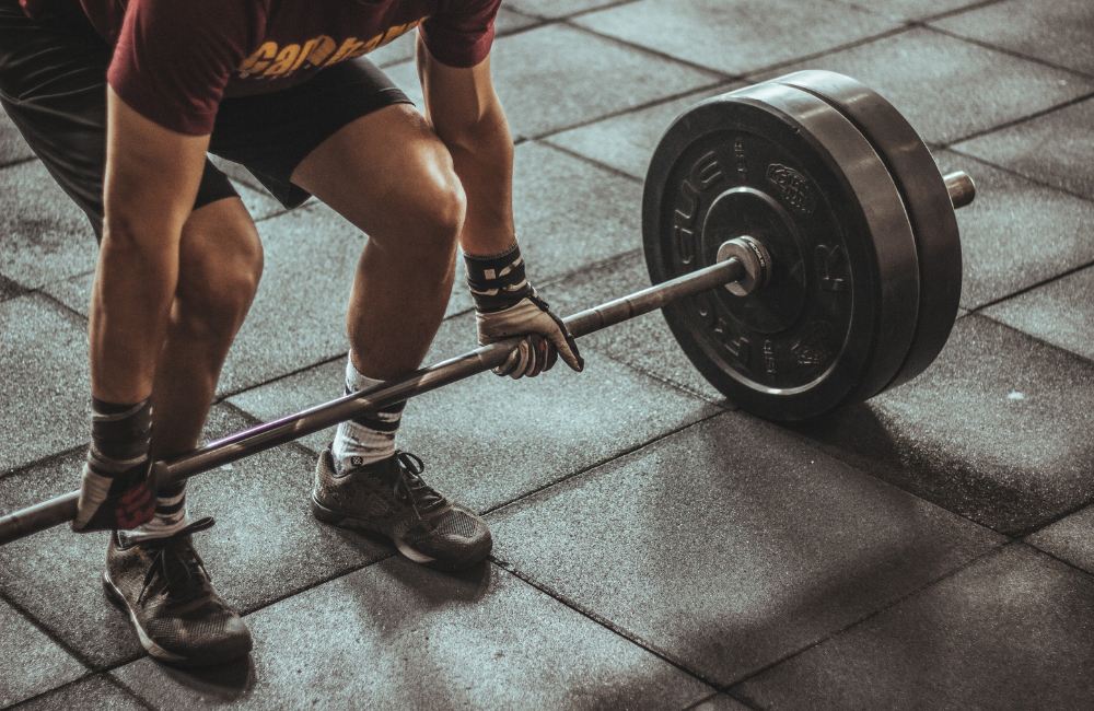 A fit man person doing exercise and MassZymes by BiOptimizers